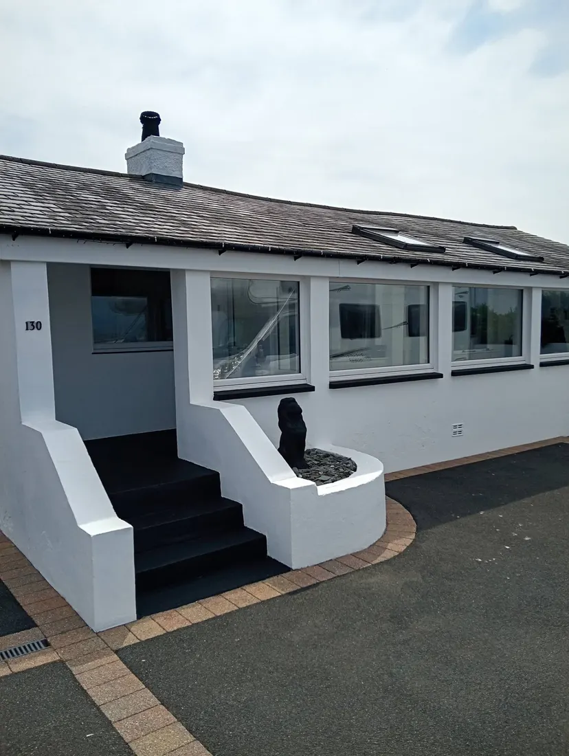 White painted bungalow exterior by CH Supreme Decor